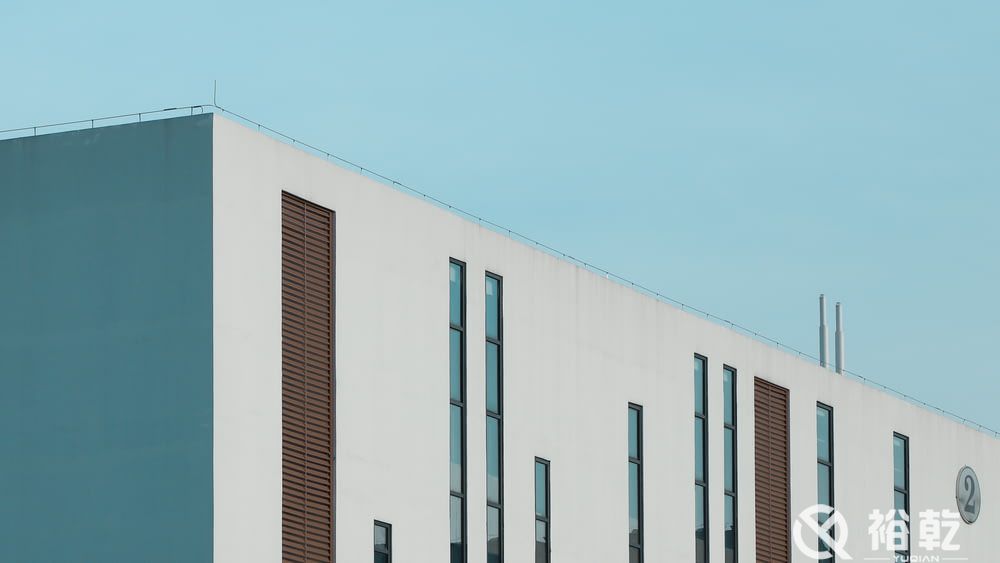 white concrete building under blue sky during dayti.jpg